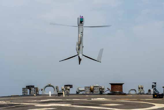 FlexRotor drone &ndash; a metal cylinder in the air with rotor blades spinning to keep it airborne.